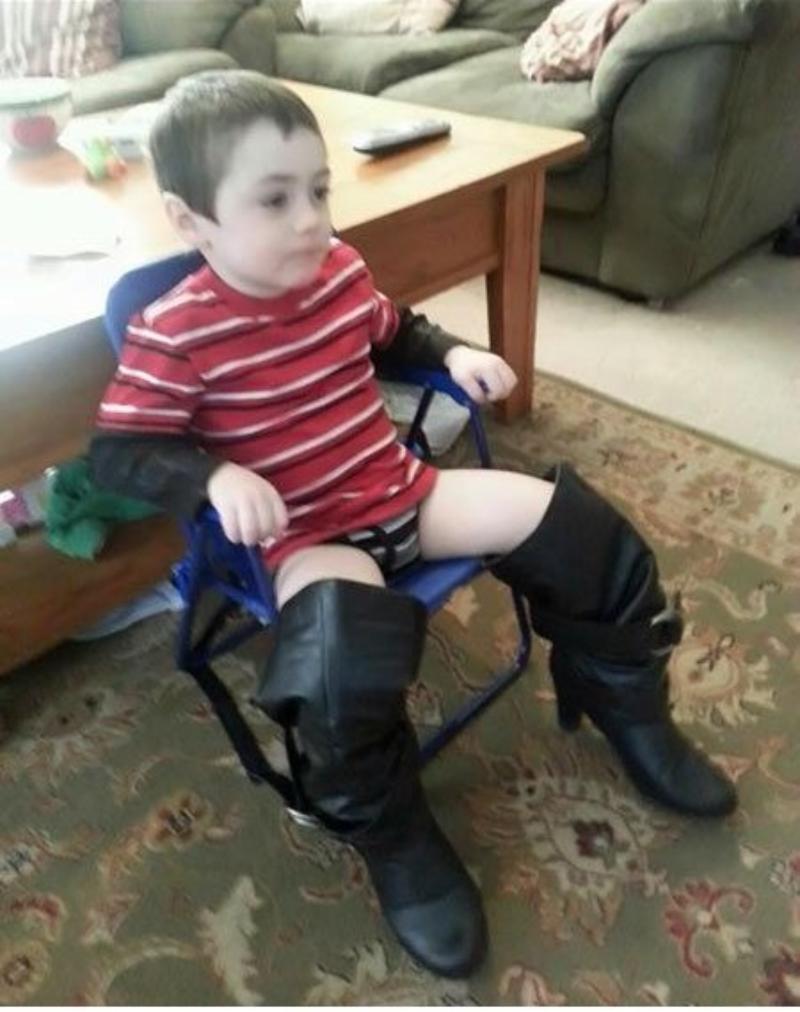 boy wearing his mommy's boots