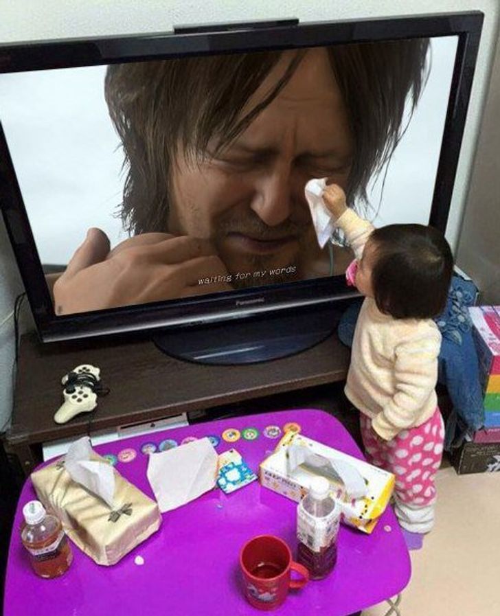 little girl wipes away the tears of a man on the TV