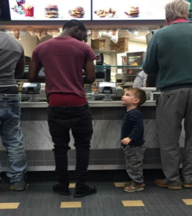 kid wondering why this man's pants are falling down