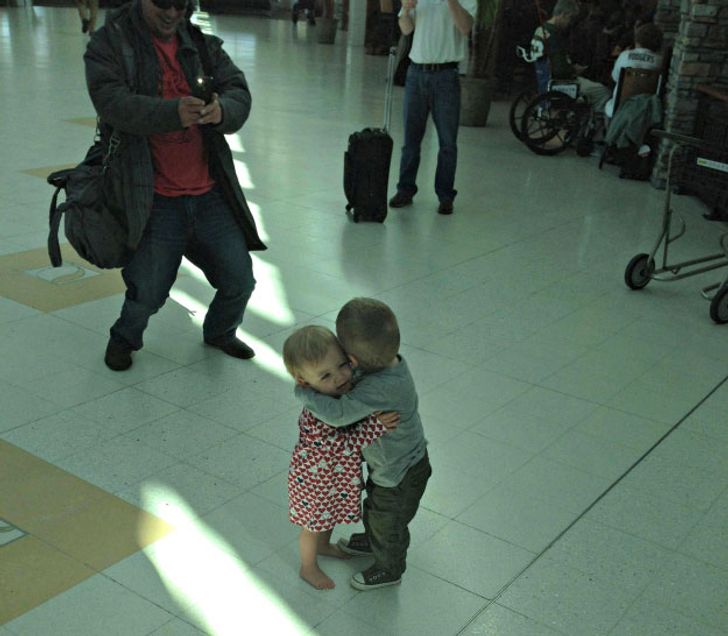 two kids who decided to have a moment at the airport