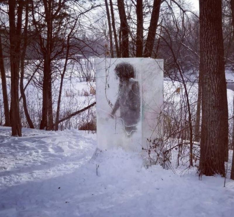 Icy Sculpture With A Frozen Cavemen Appears In A Minneapolis Park